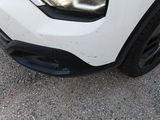 a close up of a white car with black rims
