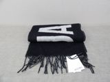 the scarf is black and white with the letter a on it