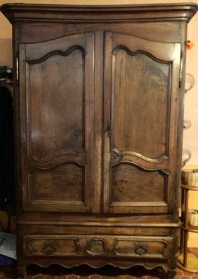 a wooden armoire with a mirror on top of it