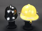 two helmets sitting on top of each other on a black table