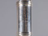 a close up of a silver vase with a silver handle
