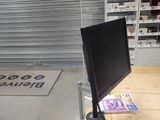 a desk with a computer monitor on it in a store