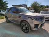 a silver range rover parked in a parking lot