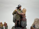 a figurine of a man and woman hugging each other