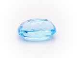a close up of a blue topazte stone on a white surface