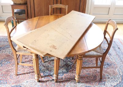 an image of a dining room table with chairs and a rug