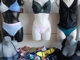 several mannequins and lingersuits on display in a clothing store