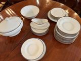 a lot of plates and bowls on the table