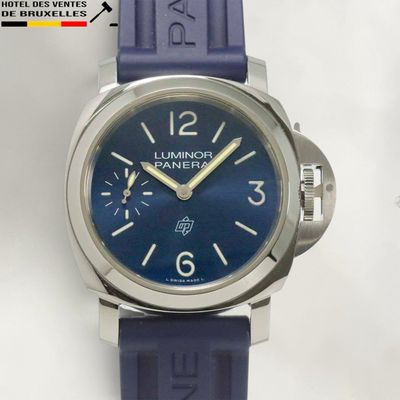 a close up of a watch on a white surface