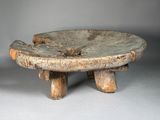 a small wooden table with two wooden legs on it
