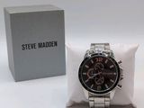 a watch that is sitting on a pillow next to a box