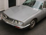 a silver car that is parked on the side of the street