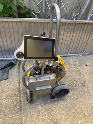a small cart that has a monitor on top of it