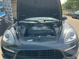 the front of a black car with its hood open and the hood open
