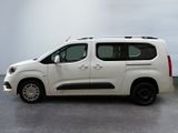 the white van is parked on the concrete floor in the room