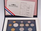 an open box of coins sitting on top of a table