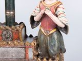 a figurine of a man with a hat on a boat