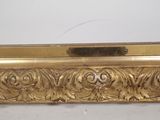 a picture of a gold frame on a white surface