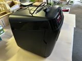 a small black machine sitting on a table in a store