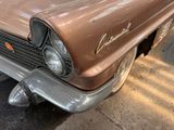 a brown car that is parked on the side of the street