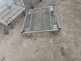 a metal cart that is sitting on the ground next to other carts