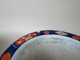 a blue and orange vase sitting on a table