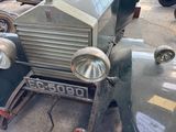 an old car that is parked on the side of the street