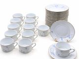 a lot of cups and saucers sitting on a table