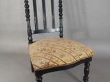 a black chair with a patterned seat and back