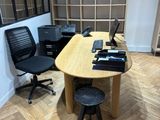 a desk with a chair and a laptop on it