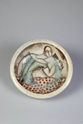 a small bowl with a picture of a woman on it