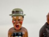 two figurines of a man and a woman on a white background