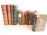 plusieurs vieux livres empilés sur une surface blanche