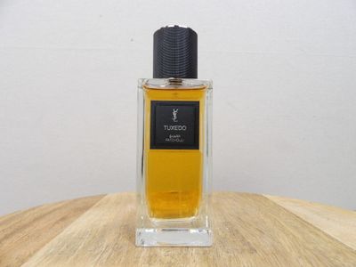 an image of a bottle of perfume sitting on a wooden table