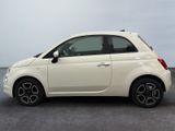 the small white car is parked in the parking lot