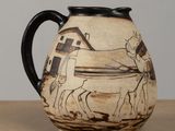 a vase with a horse drawn on it sitting on a table