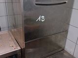 a stainless steel dishwasher sitting in the corner of a kitchen