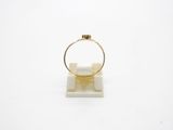 a gold ring sitting on top of a white marble block