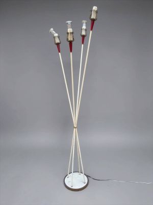 three white and red sticks are standing on a white stand
