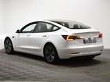 the back of a white tesla model s parked in a room