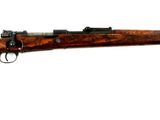Ce fusil est en bois et possède un canon en métal.