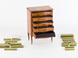 a small chest of drawers with a lot of drawers in it