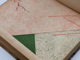 an open book with a drawing on it sitting on a table