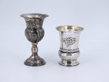 pair of silver goblets on a white surface with a white background