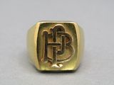 a close up of a gold ring with a initials on it