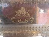 a silver plate with a picture of a lion on it