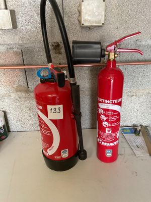 a fire extinguisor and a fire hose on a counter
