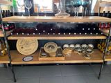 many bottles of wine and glasses on a shelf