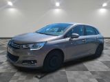 a silver car is parked on a checkered floor in a room