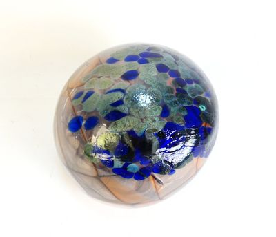 a glass ball with blue and green speckles on it